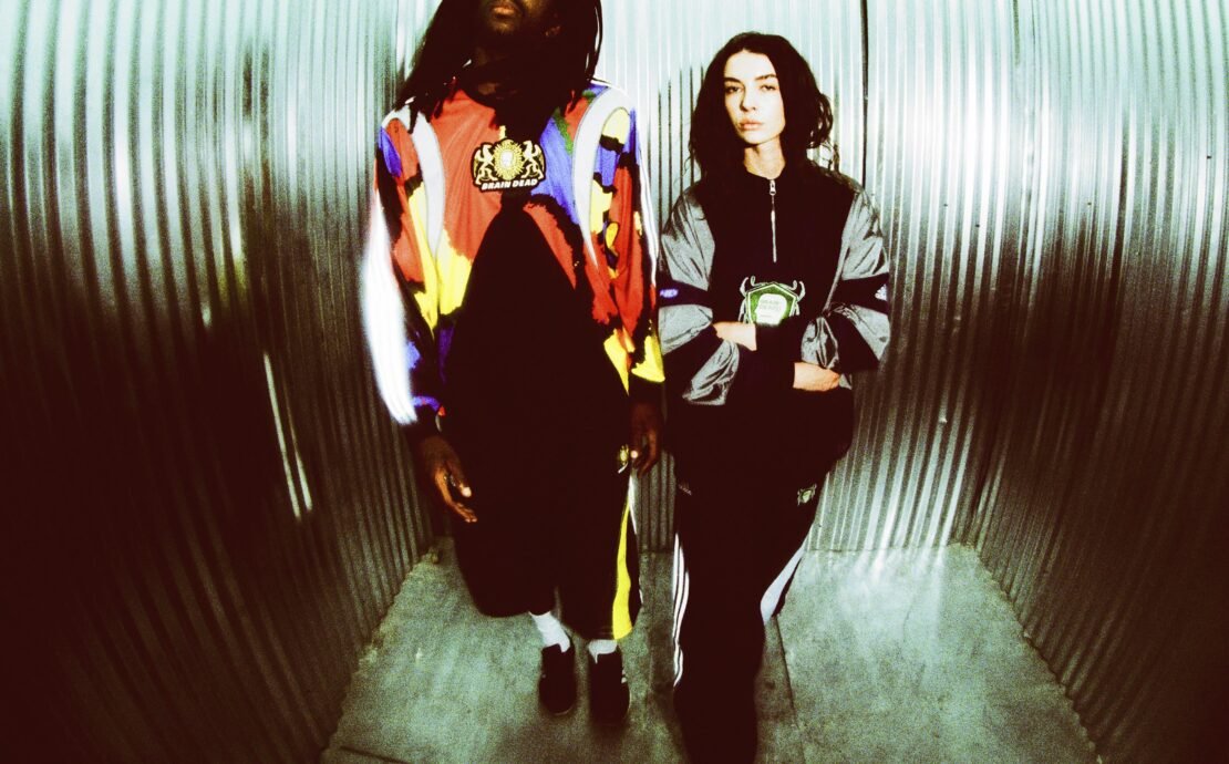 Having previously partnered on a number of collaborative collections, including takes on Tennis culture, Japanese Wrestling style, and a selection of iconic adidas silhouettes, this December, Brain Dead and the brand with the Three Stripes return to present a head-to-toe nostalgic capsule. Channeling the bold sporting and video game energy of the 2000s, the latest adidas Originals x Brain Dead collection delivers a full head-to-toe offering. The collection features reflective silver elements and shaped panels inspired by the adidas archive for apparel, along with two standout retro-futuristic silhouettes, also inspired from the adidas archive, complemented by matching accessories. The apparel offering boasts a number of key pieces, including a Japanese Noragi inspired Climacool track top and matching track pants, a metallic football-esque jersey and matching shorts, and an all over print goalkeeper jersey, as well as a track top, track pants, and a t-shirt. Each piece features Brain Dead graphics and custo crests. Rounding out the collection in the form of accessories are a sling bag and beanie. The footwear selection focuses on two silhouettes: the Climacool 2 and the Taekwondo Mei. Born in 2003 as the followup to the OG adidas Climacool sneaker, the Climacool 2 saw the silhouette updated with a futuristic vent system. Now, Braindead has brought its distinct aesthetic sensibility to the silhouette, featuring metallic vents, reflective green mesh, and yellow accents. The Taekwondo Mei Brain Dead, meanwhile, features a black upper with white stripes and an off-white outsole. Brain Dead and adidas Originals have produced a line of two collectibles inspired by classic video game culture, blending nostalgic aesthetics with the brand’s signature surreal style. These limited-edition figures capture the playful, experimental spirit of the early 2000s and will be raffled exclusively on CONFIRMED, running for the duration of the collection’s availability. While the collection can be purchased directly, the collectibles can only be won via raffle. Arriving in limited quantities on December 18th, the adidas Originals x Brain Dead collection is available via CONFIRMED, select adidas stores, select retailers, and on wearebraindead.com.